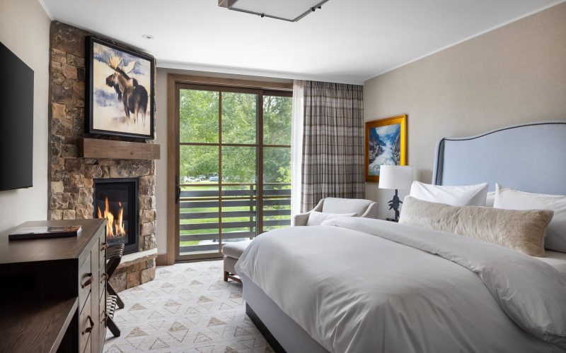 king bed hotel room with fireplace and balcony jackson hole