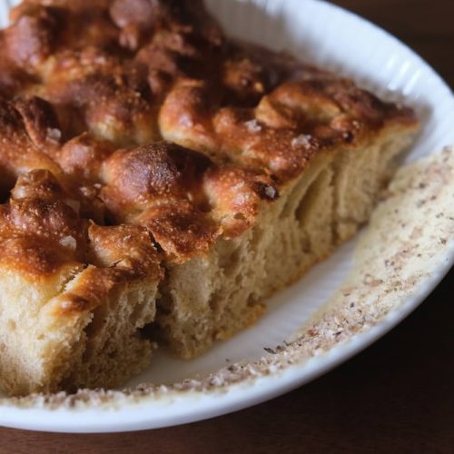 Slice of apple cinnamon coffee cake on a white plate.